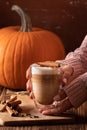 Woman hand holding homemade pumpkin spice latte made from scratch Royalty Free Stock Photo