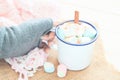 Woman hand holding hot chocolate with marshmallows. Cozy winter, Pastel colour tone Royalty Free Stock Photo