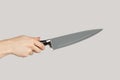 Woman hand holding huge sharp kitchen knife. Royalty Free Stock Photo