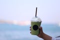 Woman hand holding Iced matcha milk for summer drink