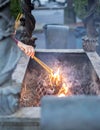 Woman hand holding incenses sticking in burner at chinese shrine with bokeh and blurred background. Faith and religious Royalty Free Stock Photo