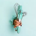 Woman hand holding kitchen utensils on blue background. Baking tools - brush, whisk, spatula. Bakery, cooking, healthy homemade Royalty Free Stock Photo