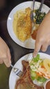 Woman hand holding knife and fork cutting grilled beef steak on stoned plate. Selective focus Royalty Free Stock Photo