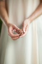 Woman hand holding little crystal mineral rock, sensual studio shot with soft light