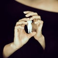 Woman hand holding little doll, melancolic sensual studio shot with Royalty Free Stock Photo