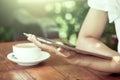 Woman hand holding and looking on digital tablet in coffee shop Royalty Free Stock Photo