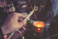 Woman hand is holding magic wand performing a pagan witch ritual. Toned to cold colors Royalty Free Stock Photo