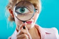 Woman hand holding magnifying glass on eye Royalty Free Stock Photo