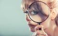 Woman hand holding magnifying glass on eye Royalty Free Stock Photo