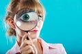 Woman hand holding magnifying glass on eye Royalty Free Stock Photo