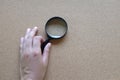 Woman hand holding  Magnifying glass  isolate on a brown background Royalty Free Stock Photo