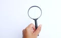 Woman hand holding  Magnifying glass  isolate on a white background Royalty Free Stock Photo