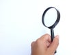 Woman hand holding  Magnifying glass  isolate on a white background Royalty Free Stock Photo