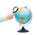 Woman hand holding magnifying glass over globe Royalty Free Stock Photo