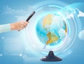 Woman hand holding magnifying glass over globe Royalty Free Stock Photo