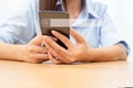 Woman hand holding mobil phone to find out online what interests them searching information data on internet networking