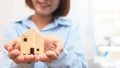 Woman hand holding a model wooden house Royalty Free Stock Photo