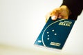 Woman hand holding new Passporte of the RepÃÂºblica Federativa do Brasil - Mercosur Passport - Important document for foreign