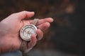 Woman hand holding a old compass with broken glass. Travel concept, path selection, navigation, tourism, hiking. Autumn background Royalty Free Stock Photo