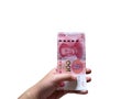 Woman hand holding one hundred Chinese yuan money stacking isolated on white background. Royalty Free Stock Photo