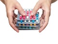 Woman hand holding pack of antibiotic capsule pills isolated on white background. Give or receive drug. Antibiotic drug overuse.