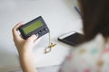 Woman hand holding a pager on white table ,  One way pager or a beeper can only receive messages  , selective focus Royalty Free Stock Photo