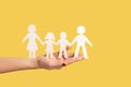 Woman hand holding paper family chain, relationships between children and parents. Royalty Free Stock Photo