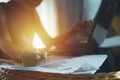 Woman hand holding pen with graph and business documents on office table and working on laptop computer. Royalty Free Stock Photo