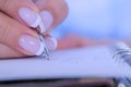 Woman hand holding pen and writing to do list in vintage notebook organizer Royalty Free Stock Photo