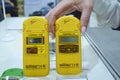 Woman hand holding personal dosimeter-radiometers for measuring levels of radiation