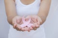 Woman hand holding pink breast cancer awareness ribbon. Royalty Free Stock Photo