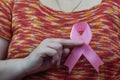 Woman hand holding pink breast cancer awareness ribbon. Royalty Free Stock Photo