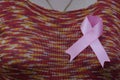 Woman hand holding pink breast cancer awareness ribbon. Royalty Free Stock Photo