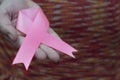 Woman hand holding pink breast cancer awareness ribbon. Royalty Free Stock Photo