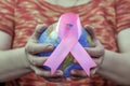 Woman hand holding pink breast cancer awareness ribbon. Royalty Free Stock Photo