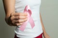 Woman hand holding pink ribbon breast cancer awareness Royalty Free Stock Photo