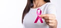 Woman hand holding pink ribbon breast cancer awareness. concept healthcare and medicine Royalty Free Stock Photo