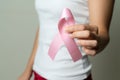 Woman hand holding pink ribbon breast cancer awareness Royalty Free Stock Photo