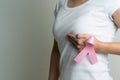 Woman hand holding pink ribbon breast cancer awareness Royalty Free Stock Photo