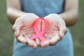 woman hand holding pink ribbon breast cancer awareness Royalty Free Stock Photo