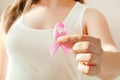 Woman hand holding pink ribbon, breast cancer awareness concept, healthcare and medicine Royalty Free Stock Photo
