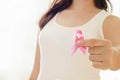 Woman hand holding pink ribbon, breast cancer awareness concept, healthcare and medicine Royalty Free Stock Photo