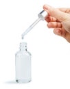 Woman hand holding pipette with collagen moisturizing hyaluron serum in a glass bottle