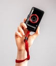 Woman hand holding point and shoot camera. Practical and compact digital device for taking photos in travel. Tourist Royalty Free Stock Photo