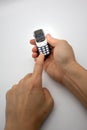 Woman hand holding the world smallest mobile phone with OLED screen in blue plastic body isolated on white Royalty Free Stock Photo