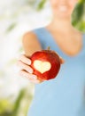 Woman hand holding red apple with heart shape Royalty Free Stock Photo