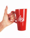 Woman hand holding a red coffee mug Royalty Free Stock Photo