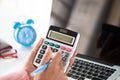 Woman hand holding red pencil and working with calculator Royalty Free Stock Photo