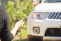 Woman hand holding the remote control to lock the car door.car security anti thief alarm system Royalty Free Stock Photo