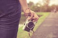 Woman hand holding retro camera. young hipster girl photographer with film camera Royalty Free Stock Photo